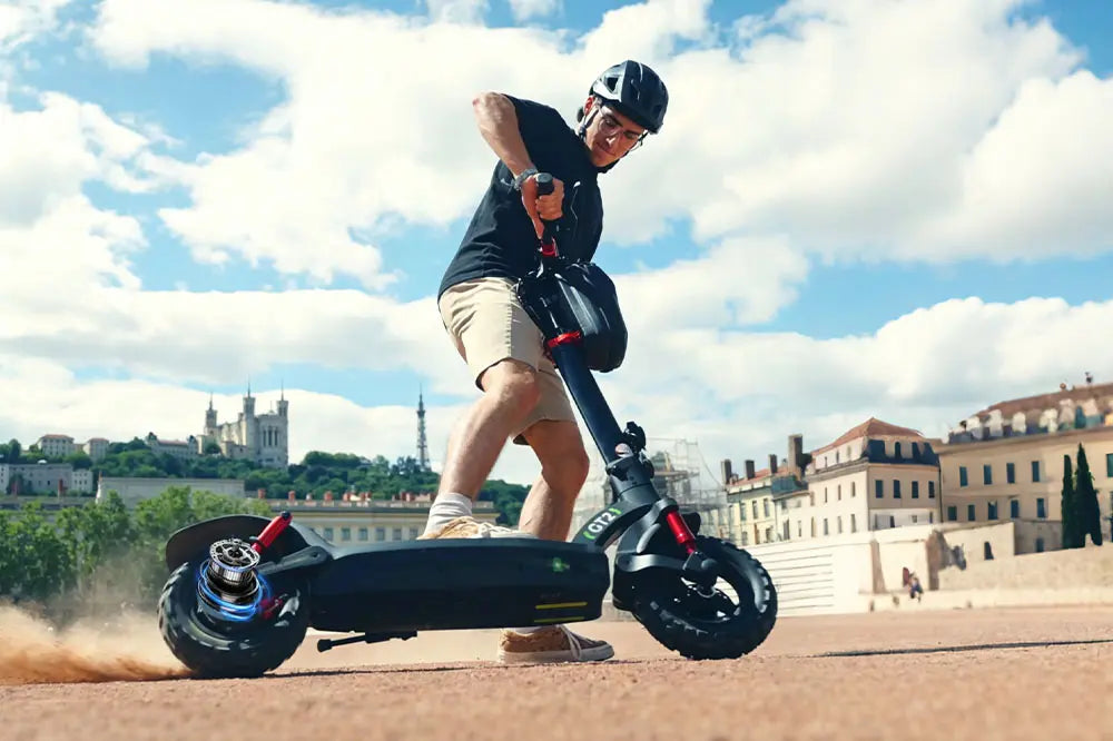 Man riding a isinwheel GT2 off-road e-scooter in an urban setting
